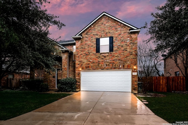 view of front property with a yard and a garage