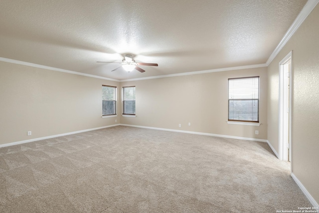 carpeted empty room featuring ceiling fan, crown molding, and a textured ceiling