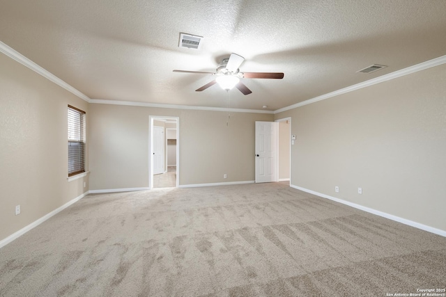 carpeted empty room with ceiling fan, a textured ceiling, and ornamental molding