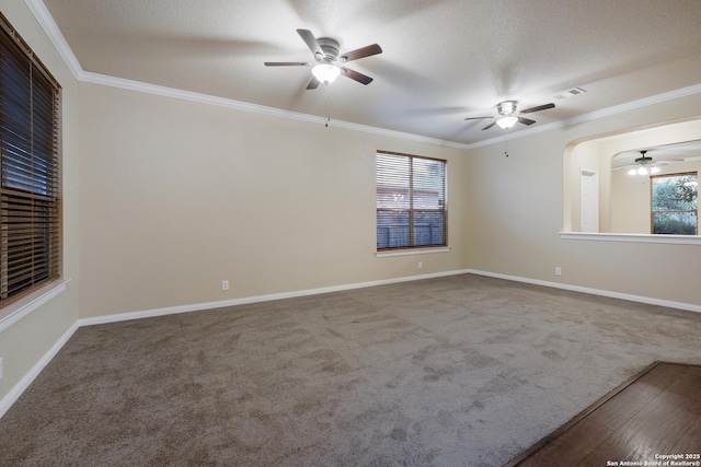 carpeted spare room with ceiling fan, a textured ceiling, and ornamental molding