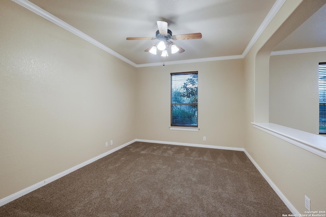 carpeted spare room with ceiling fan and ornamental molding