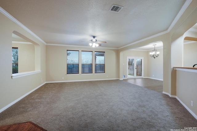 unfurnished room with carpet flooring, a healthy amount of sunlight, ceiling fan with notable chandelier, and crown molding