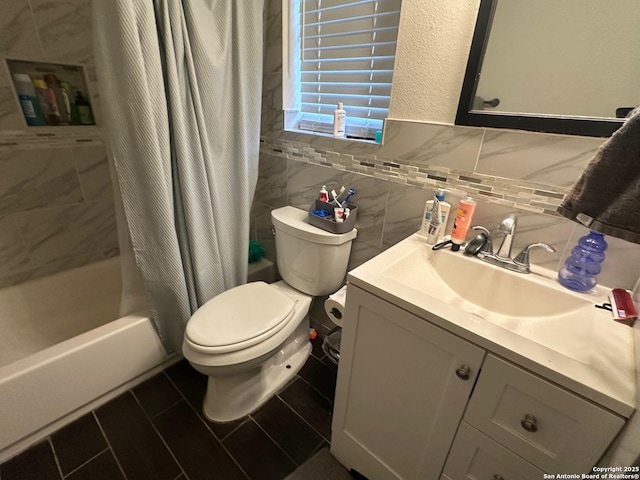 full bathroom with tile walls, toilet, decorative backsplash, vanity, and shower / tub combo