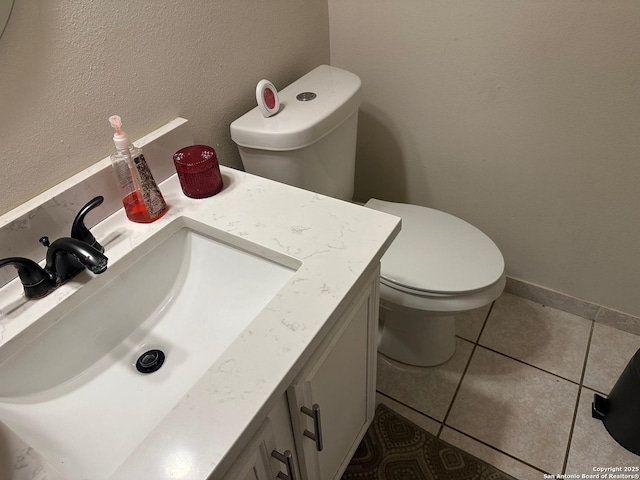 bathroom featuring tile patterned floors, vanity, and toilet