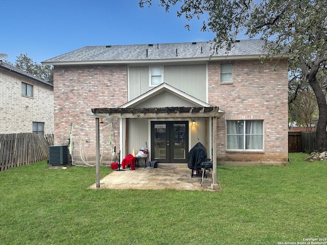 back of property featuring french doors, a yard, a patio, and cooling unit