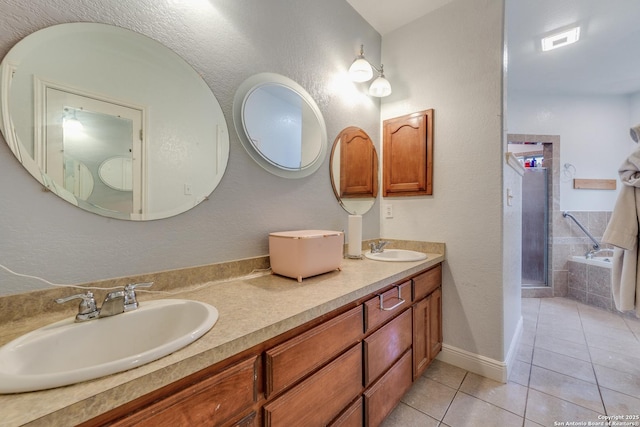 bathroom featuring tile patterned flooring, vanity, and walk in shower