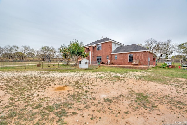 exterior space with a shed and a yard