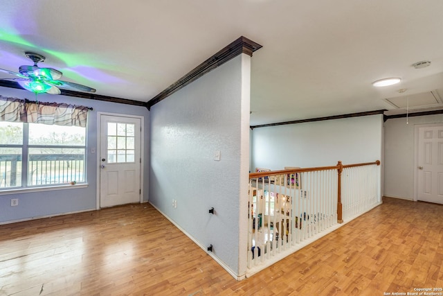 entrance foyer with ceiling fan, ornamental molding, and light hardwood / wood-style flooring