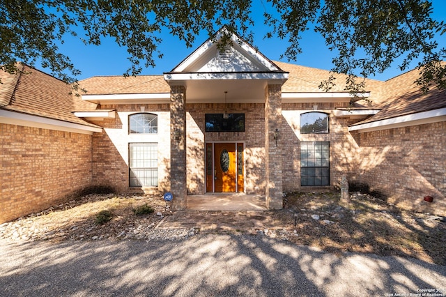 view of exterior entry featuring a patio area