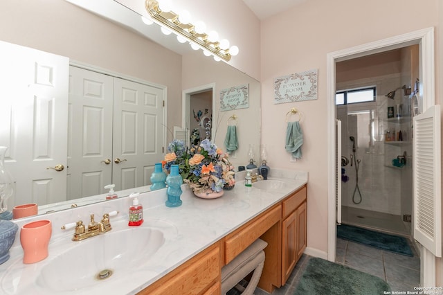 bathroom featuring a shower with door, vanity, and tile patterned floors