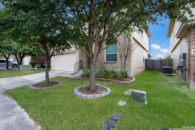 view of front facade with a garage, a front lawn, and central air condition unit