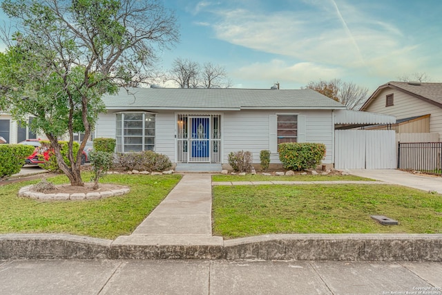 view of front facade featuring a carport and a front lawn