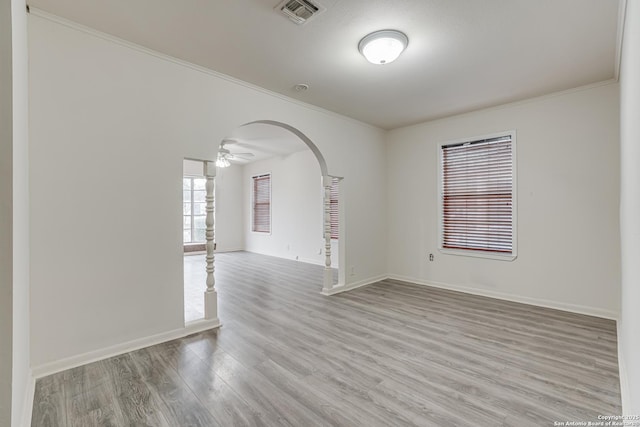 spare room with light hardwood / wood-style flooring, ceiling fan, and crown molding