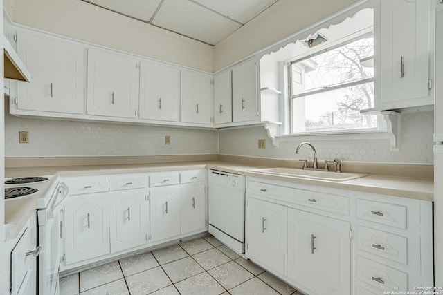 kitchen with white cabinetry, sink, light tile patterned floors, and white appliances