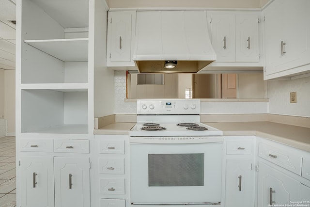 kitchen with decorative backsplash, custom range hood, light tile patterned floors, white cabinets, and white range with electric cooktop