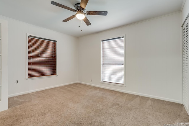 empty room with ceiling fan and light carpet