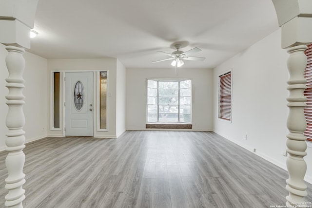 unfurnished living room featuring light wood-type flooring and ceiling fan