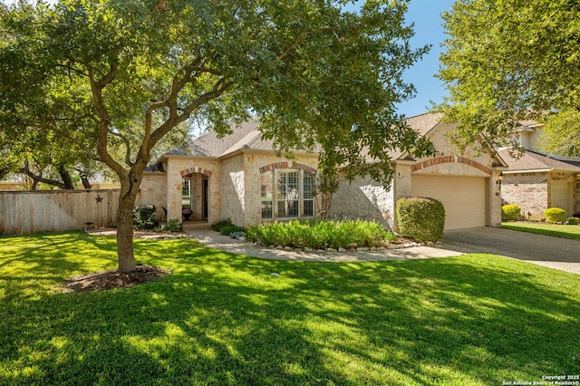 view of front of house with a front yard and a garage