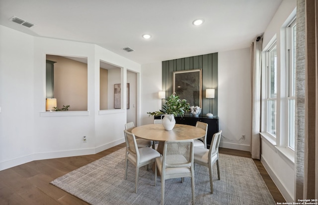 dining space with a healthy amount of sunlight and dark hardwood / wood-style flooring