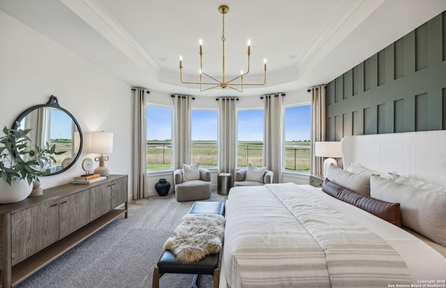 carpeted bedroom with a raised ceiling and an inviting chandelier