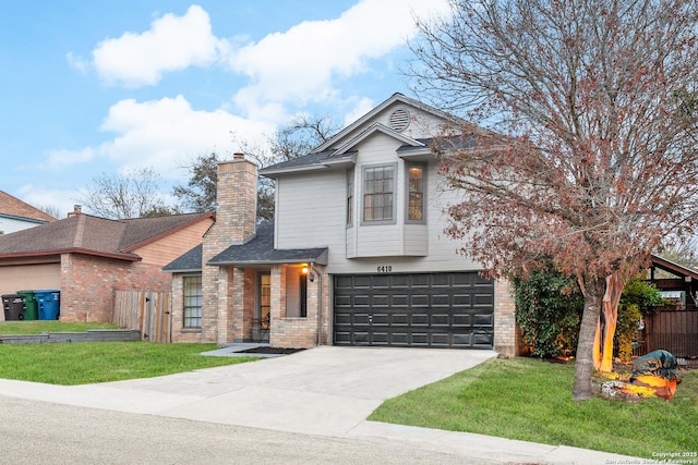 view of property with a garage and a front yard