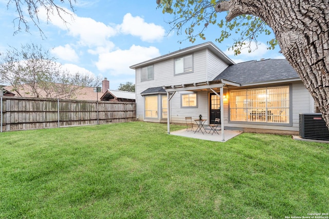 back of property with a patio, central AC, and a lawn