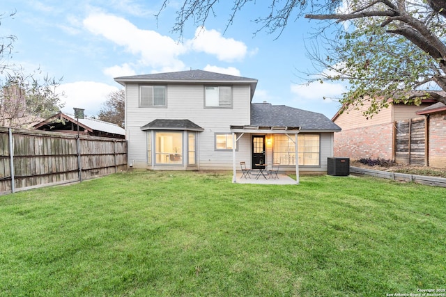 rear view of house with a lawn, central air condition unit, and a patio