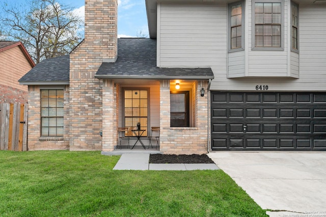 view of front of house with a front yard and a garage