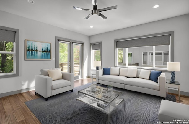 living room featuring ceiling fan and hardwood / wood-style flooring