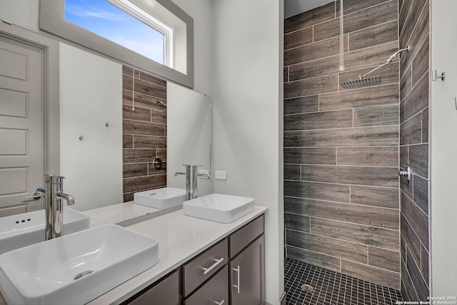 bathroom with vanity and tiled shower