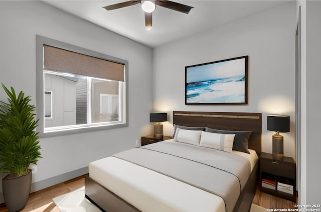 bedroom featuring ceiling fan and light hardwood / wood-style floors