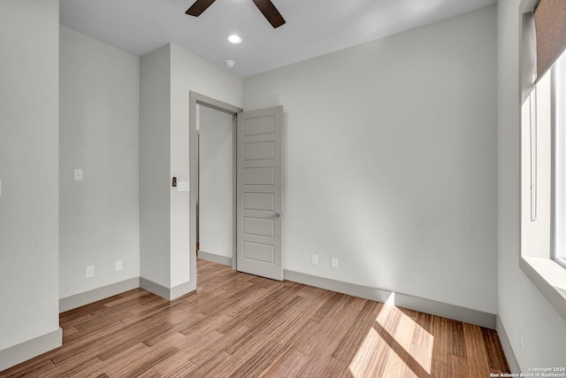 unfurnished bedroom with ceiling fan and light hardwood / wood-style flooring