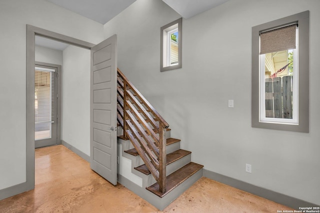 stairway featuring concrete floors