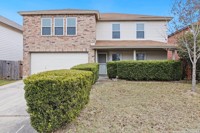 view of front of property with a front yard and a garage