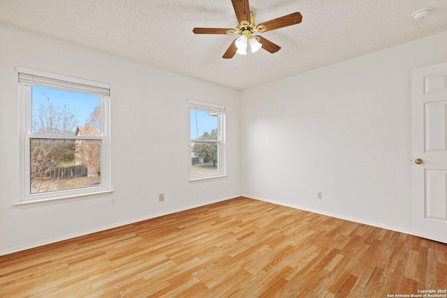 spare room featuring a textured ceiling, ceiling fan, and light hardwood / wood-style flooring