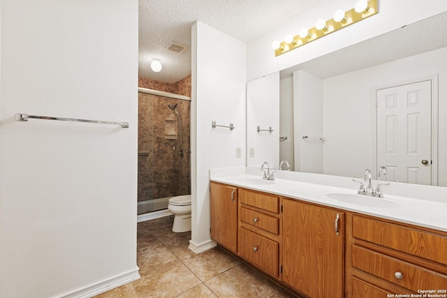 bathroom with toilet, a textured ceiling, walk in shower, tile patterned flooring, and vanity