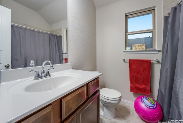 bathroom featuring tile patterned flooring, vanity, lofted ceiling, and toilet