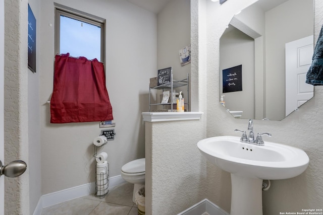 bathroom with tile patterned floors, toilet, and sink