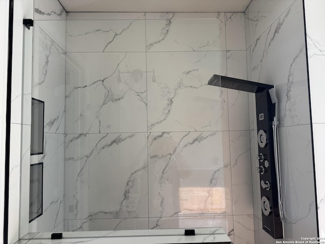 bathroom with a marble finish shower