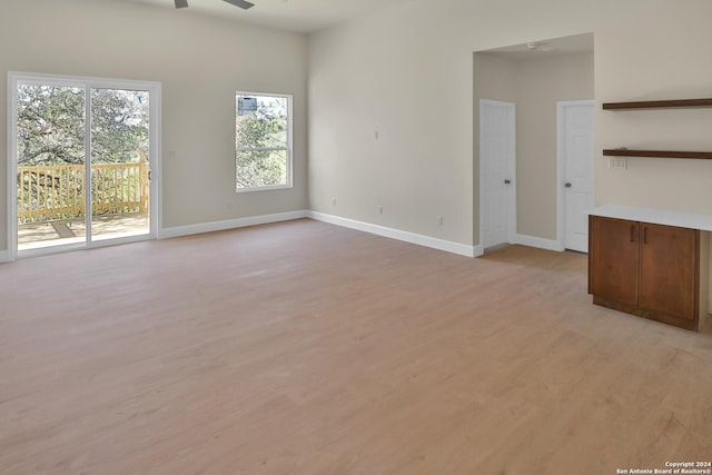 unfurnished living room with light hardwood / wood-style floors and ceiling fan