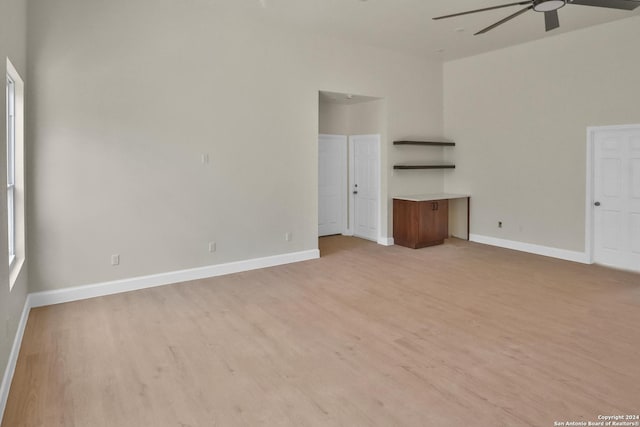 unfurnished living room featuring ceiling fan and light hardwood / wood-style floors