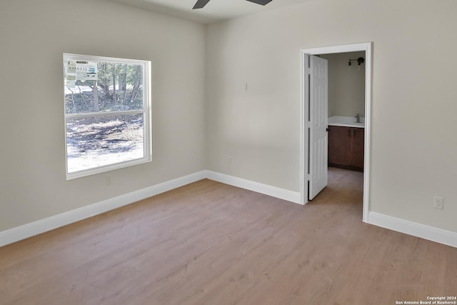 unfurnished room with light wood-type flooring and ceiling fan