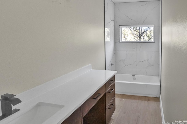 full bath with vanity, a shower, wood finished floors, and a bath