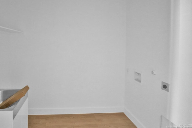 interior space with laundry area, baseboards, light wood-style floors, and electric dryer hookup