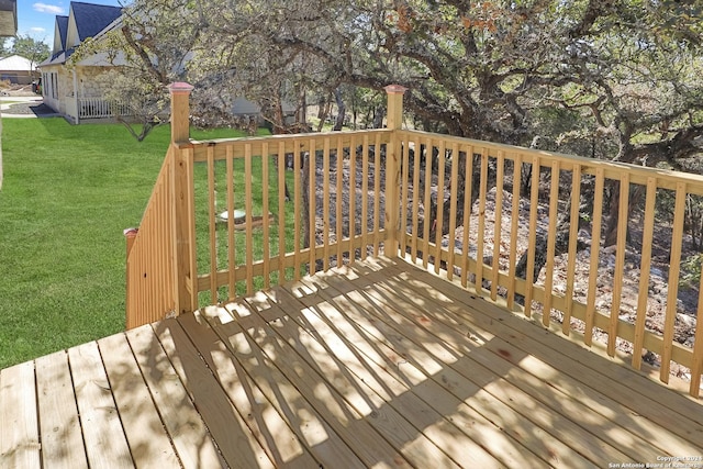 wooden terrace featuring a yard