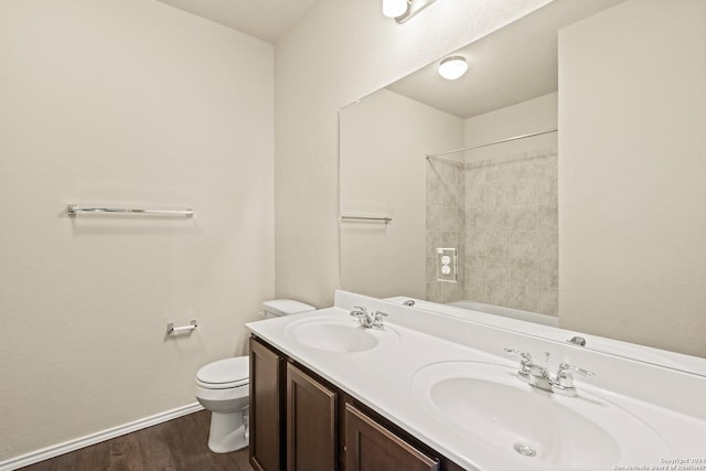 bathroom with hardwood / wood-style flooring, vanity, and toilet