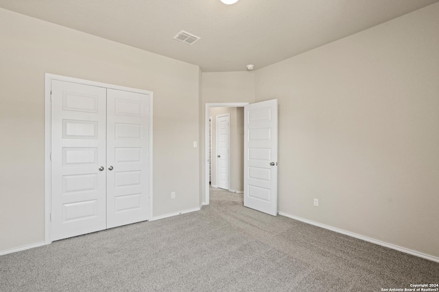 unfurnished bedroom featuring a closet and carpet floors