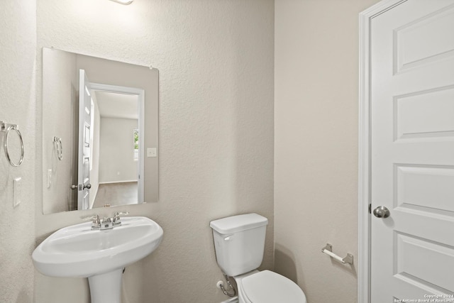 bathroom with toilet and sink