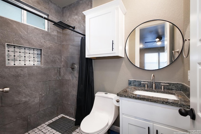 bathroom featuring vanity, toilet, plenty of natural light, and ceiling fan