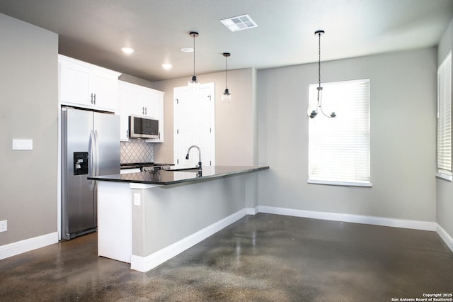 kitchen featuring backsplash, a chandelier, pendant lighting, white cabinets, and appliances with stainless steel finishes